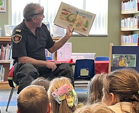 Firefighter reading to class